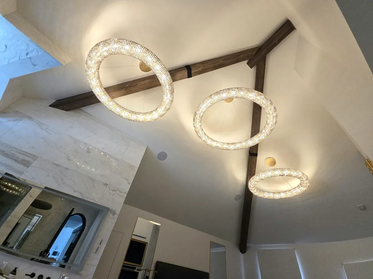Real wood beams crossing a vaulted ceiling in a finished home.